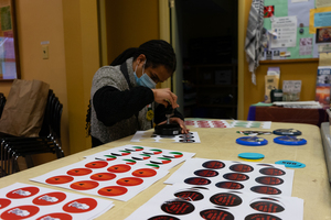 Kaeillyn Jimenez cuts out art to be made into buttons. The Syracuse Peace Council hosted an event where attendees made pro-Palestine art, including buttons, pamphlets and zines.